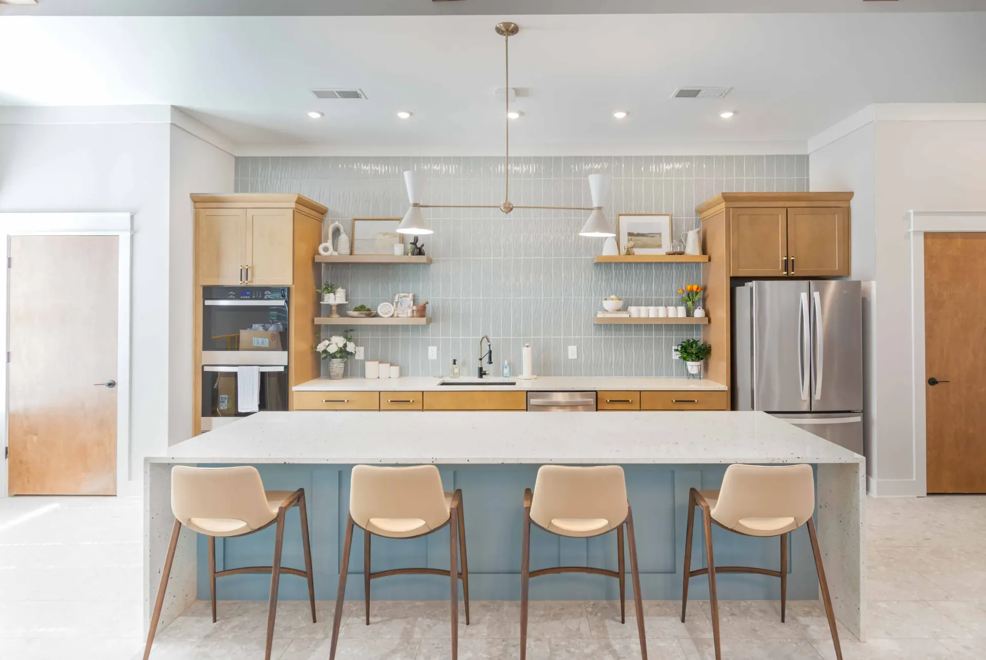 Modern kitchen with stainless steel appliances, island, and seating.