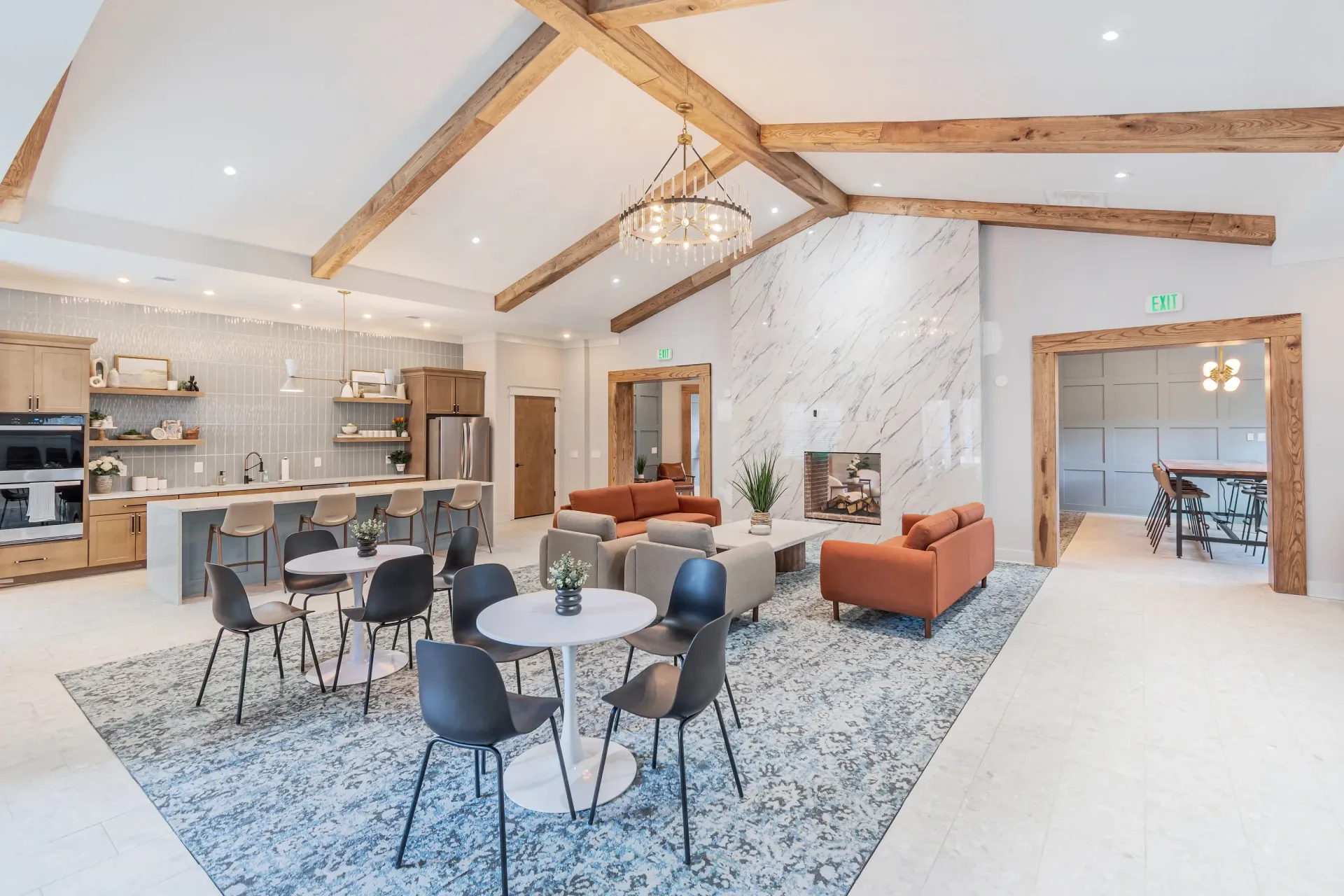 Community lounge with a kitchen, fireplace, and seating areas.