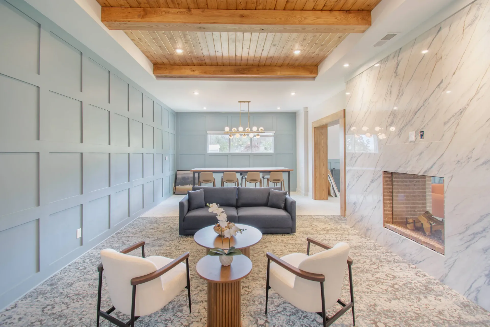 Modern living room with a fireplace and comfortable seating.