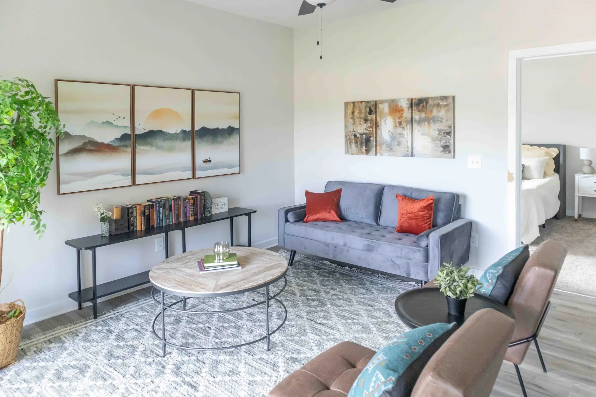Living room with a gray sofa, coffee table, and artwork.