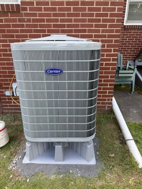 Black outdoor air conditioner unit on a white background