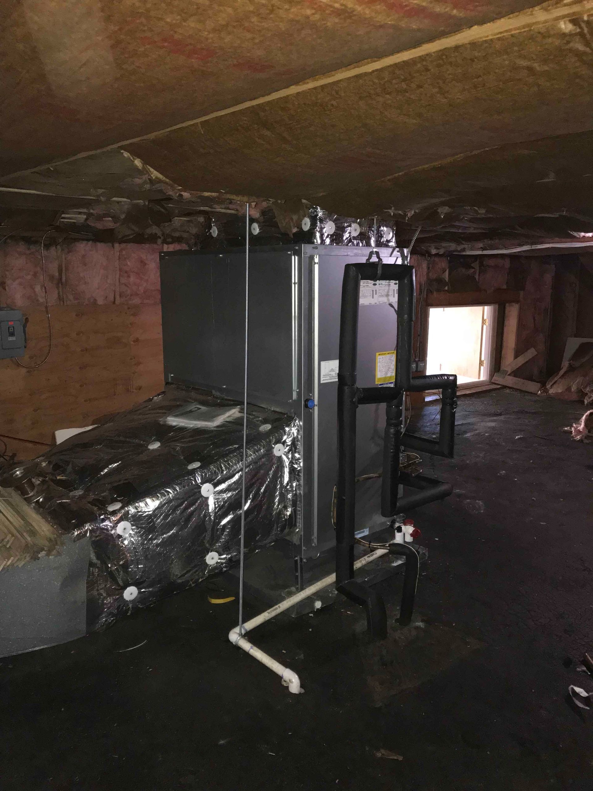 Destroyed room with blackened equipment and debris, showing fire damage inside a building.