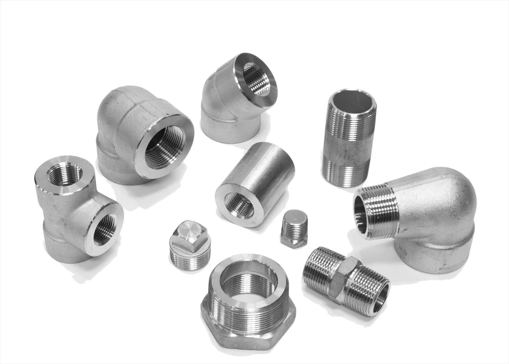Assorted silver metal pipe fittings and connectors arranged on a white background