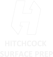 A white logo for hitchcock surface prep on a white background.