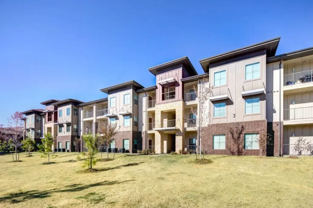 A large apartment building with a lot of windows and balconies