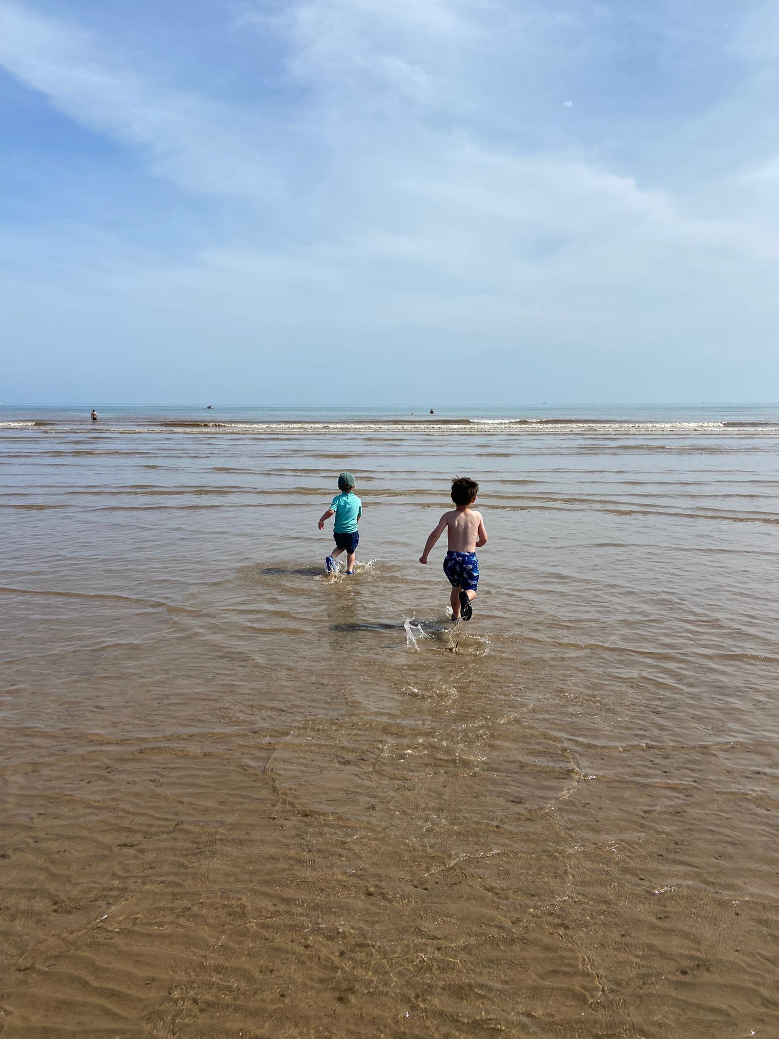 Children paddling in the shallows at the beach