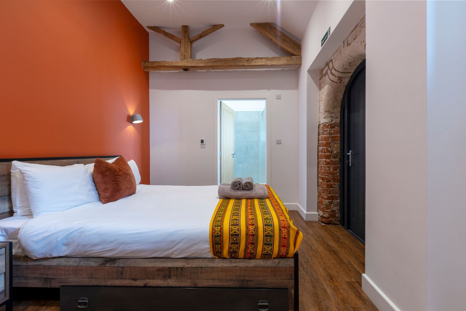 Orange bedroom with exposed beams