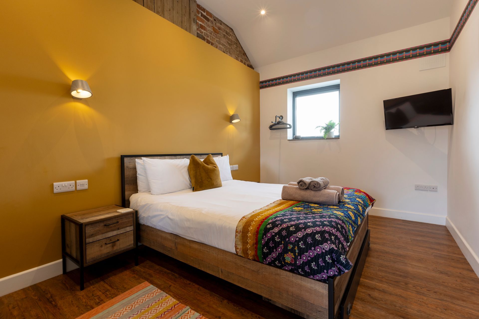 King bed with yellow fluffy cushion