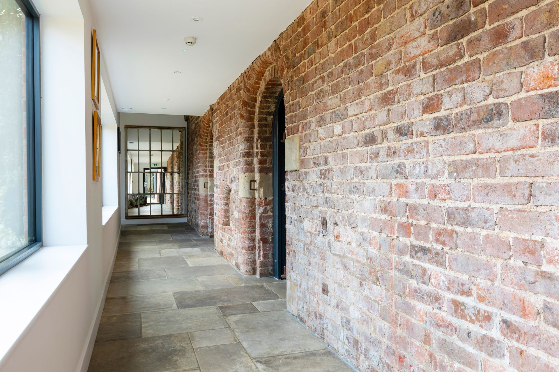 Exposed brick and glass corridor