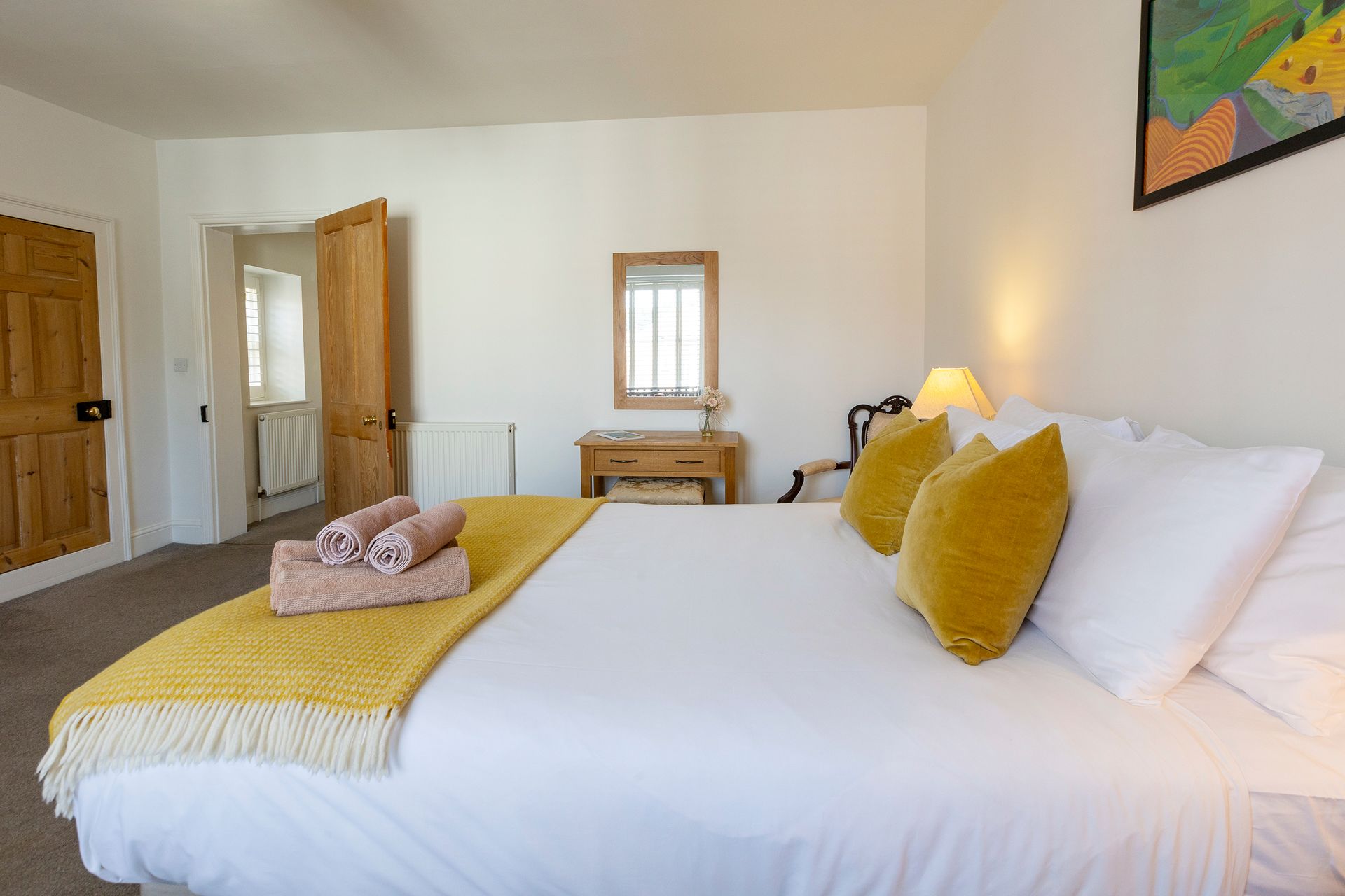 king bed with yellow throw