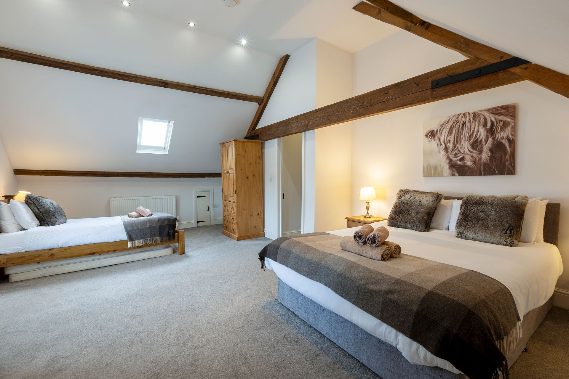 family room with king bed and single bed in the attic