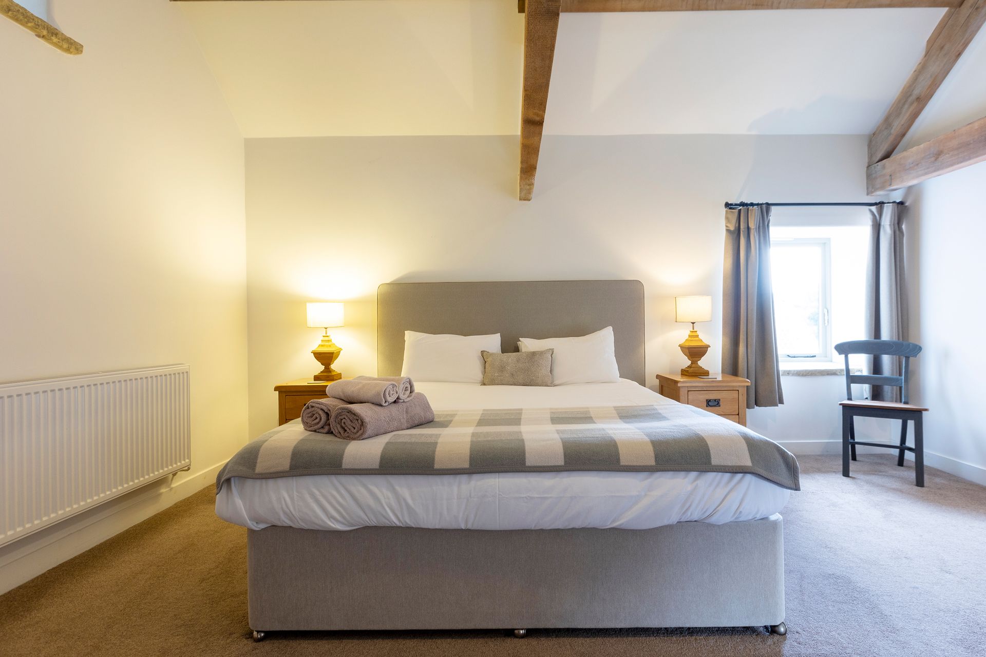 super-king bed with vaulted ceiling and exposed beams