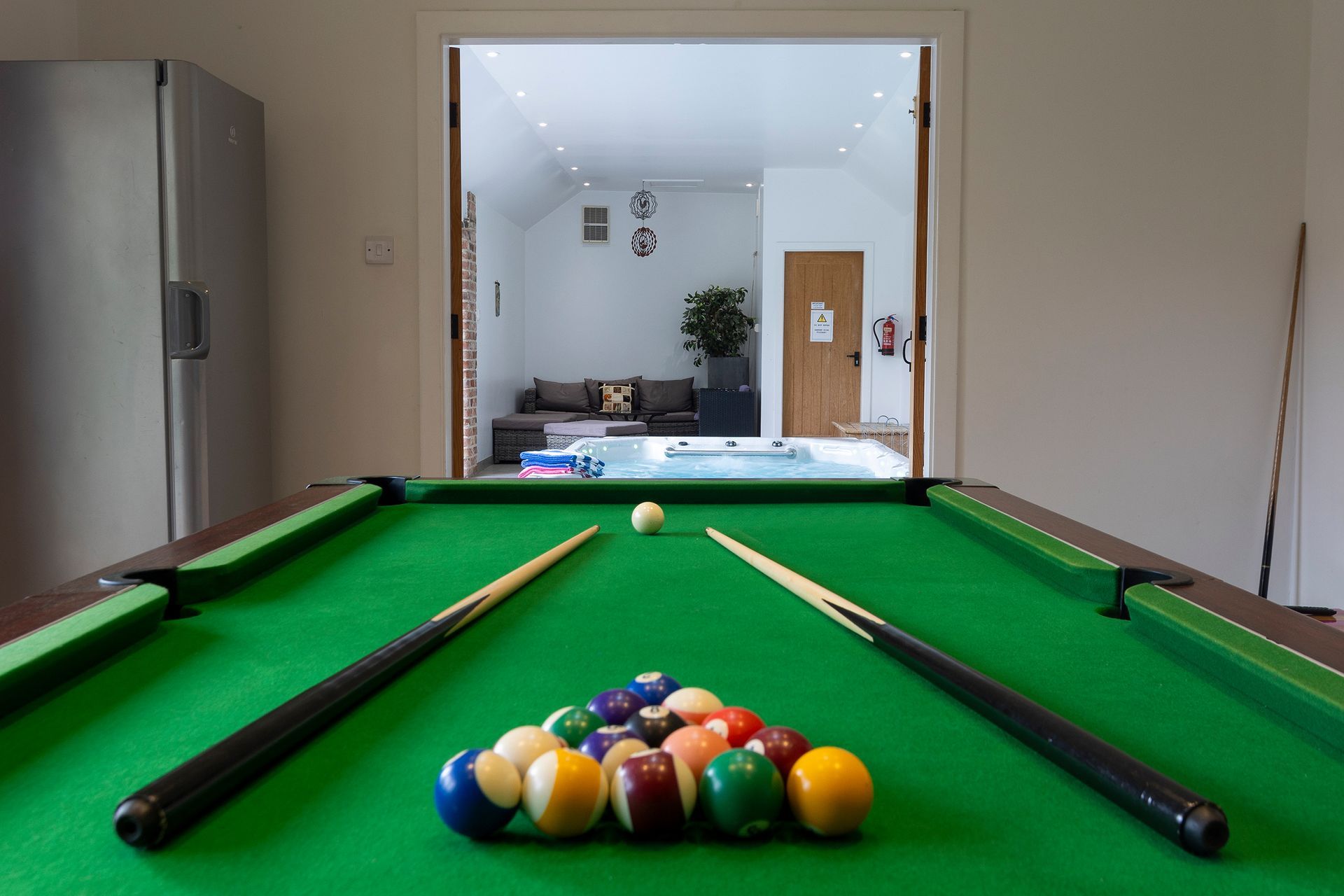 pool table looking into a room with a swim spa