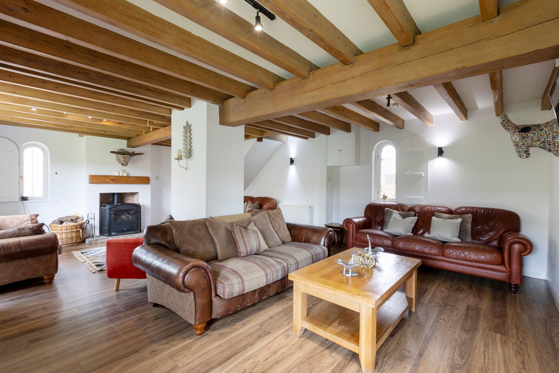 Living room with exposed beams and original features