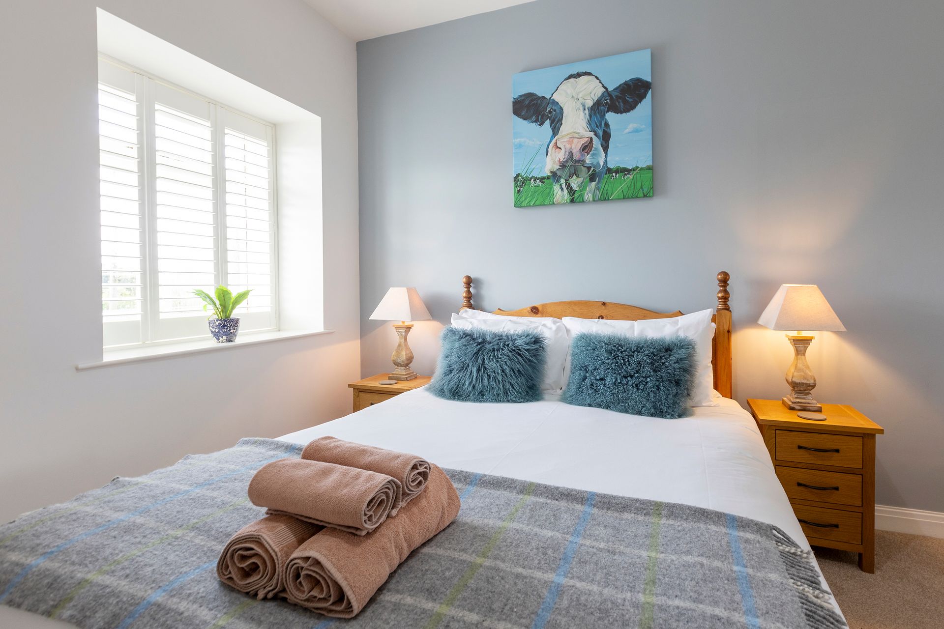 King bed and cow paiting