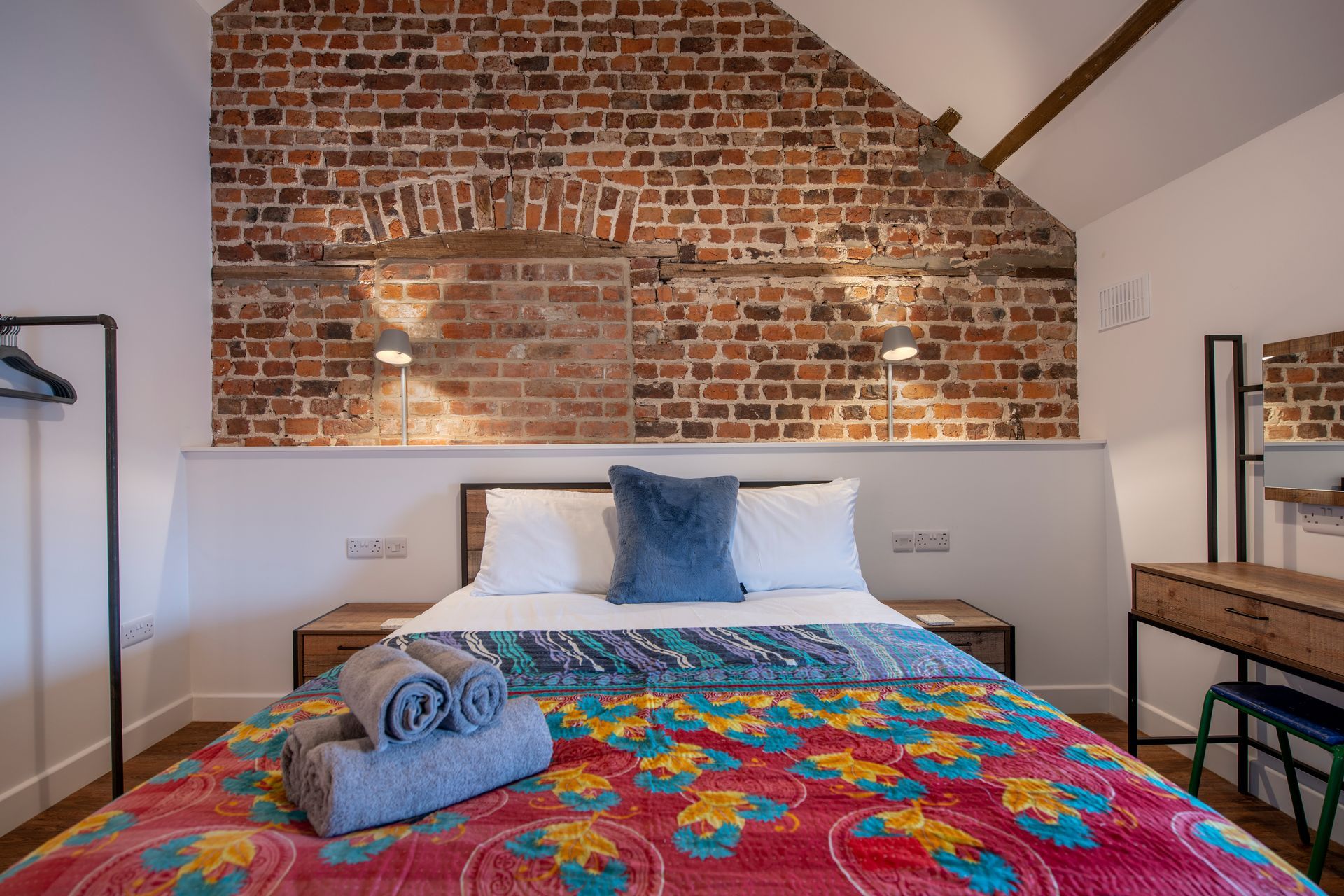 King bedroom with brick wall