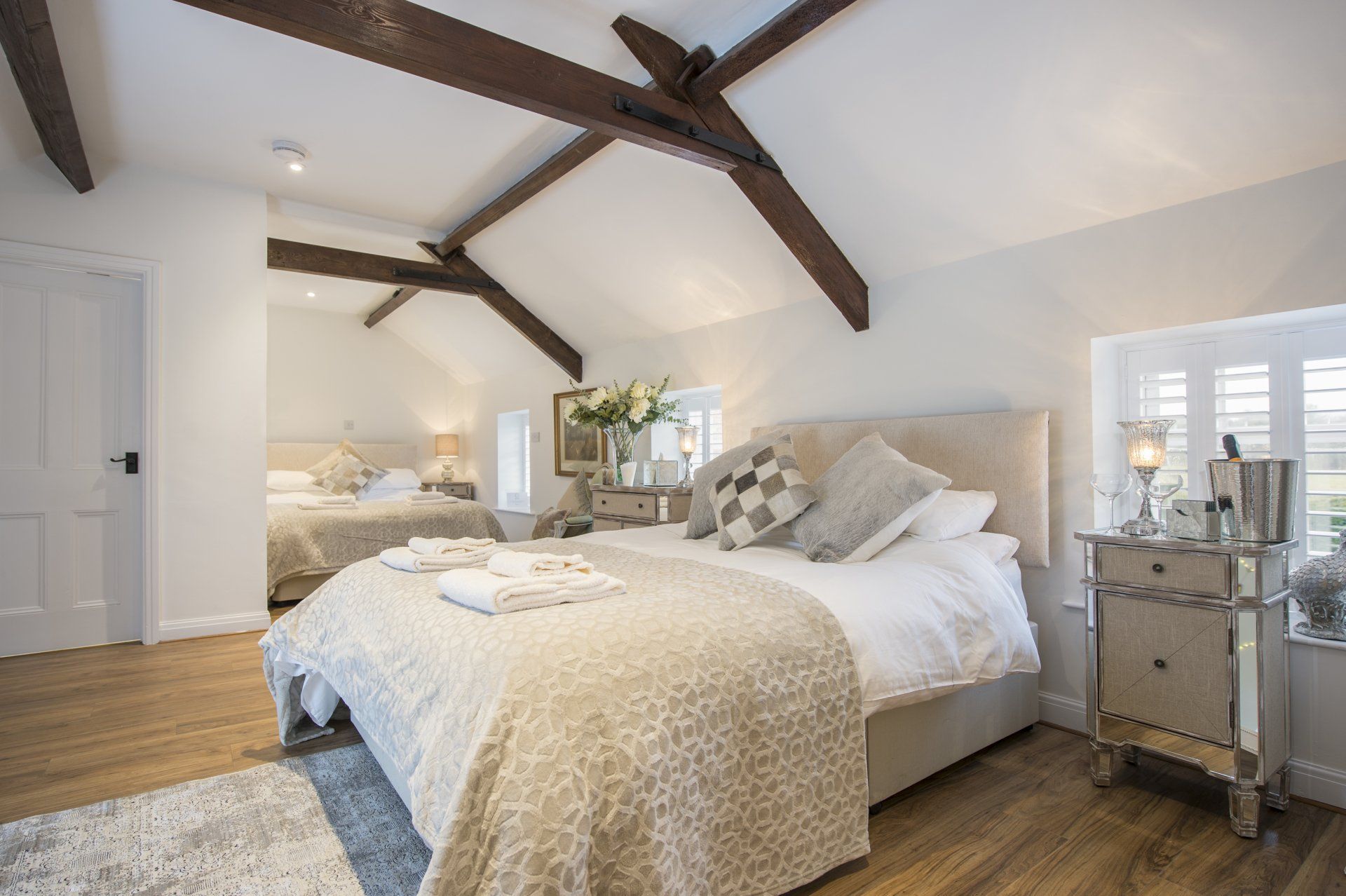 A bedroom with a king size bed and two twin beds.