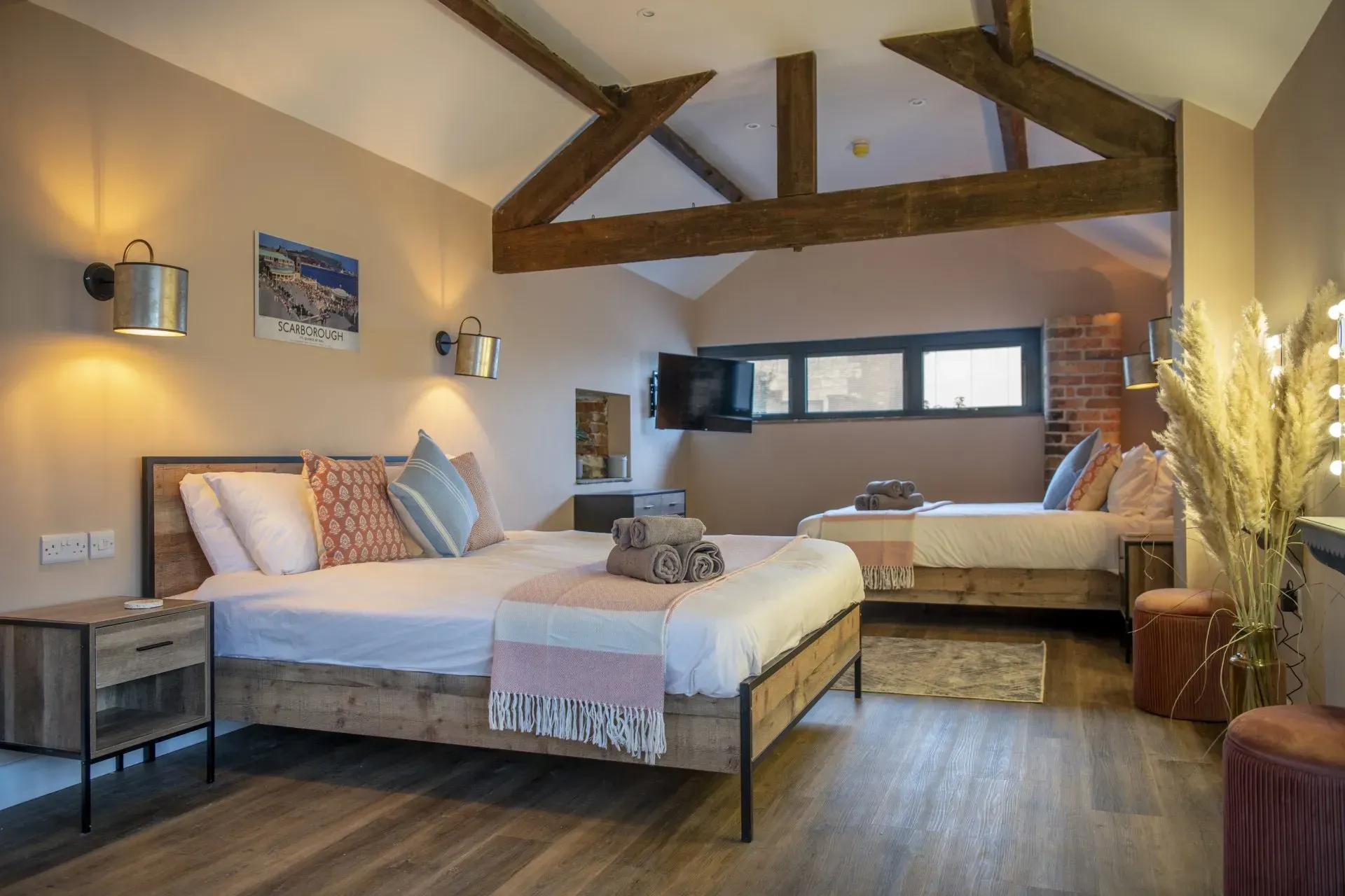 A bedroom with a bed , nightstand , and window.