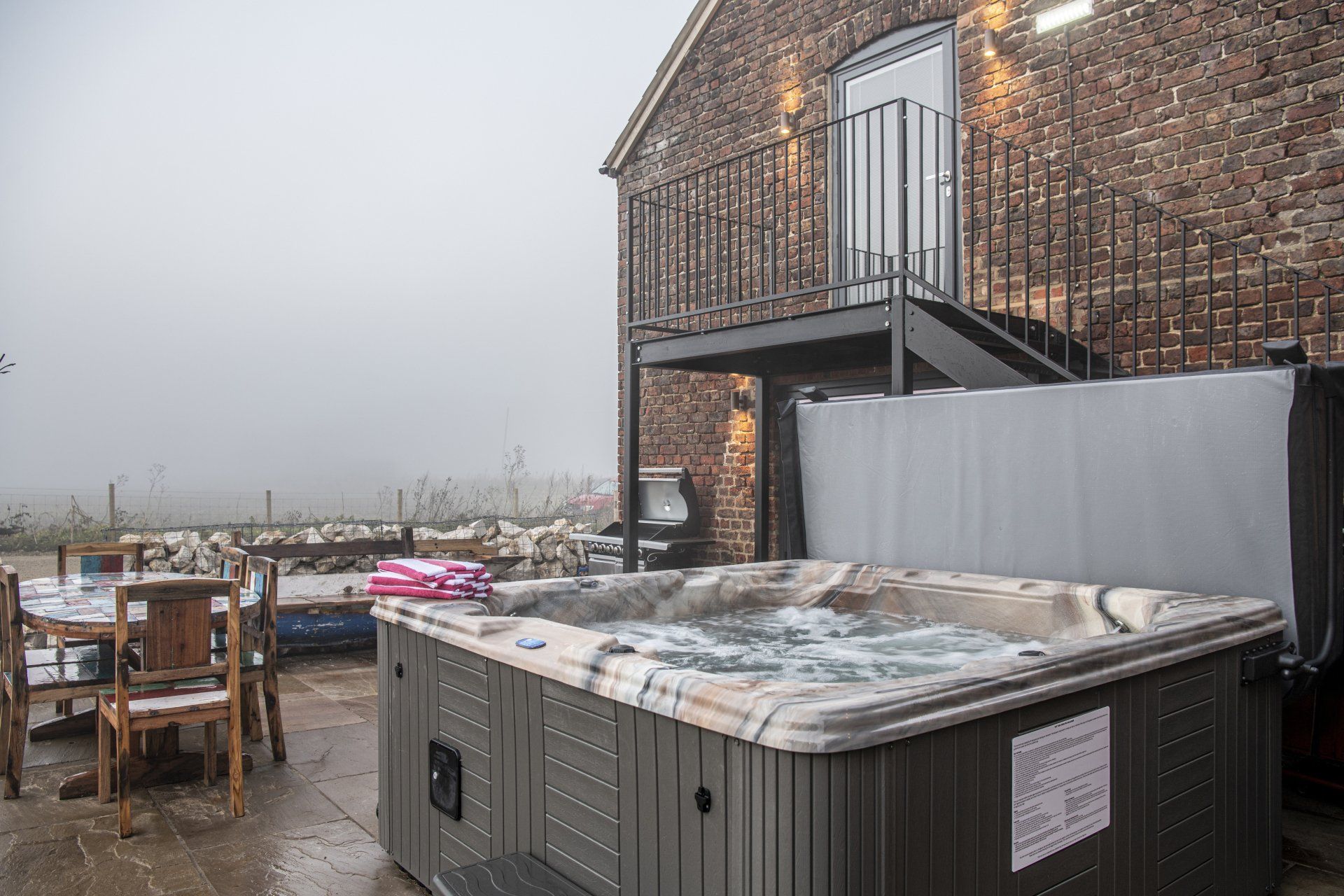 Misty autumnal morning with a hot tub steaming