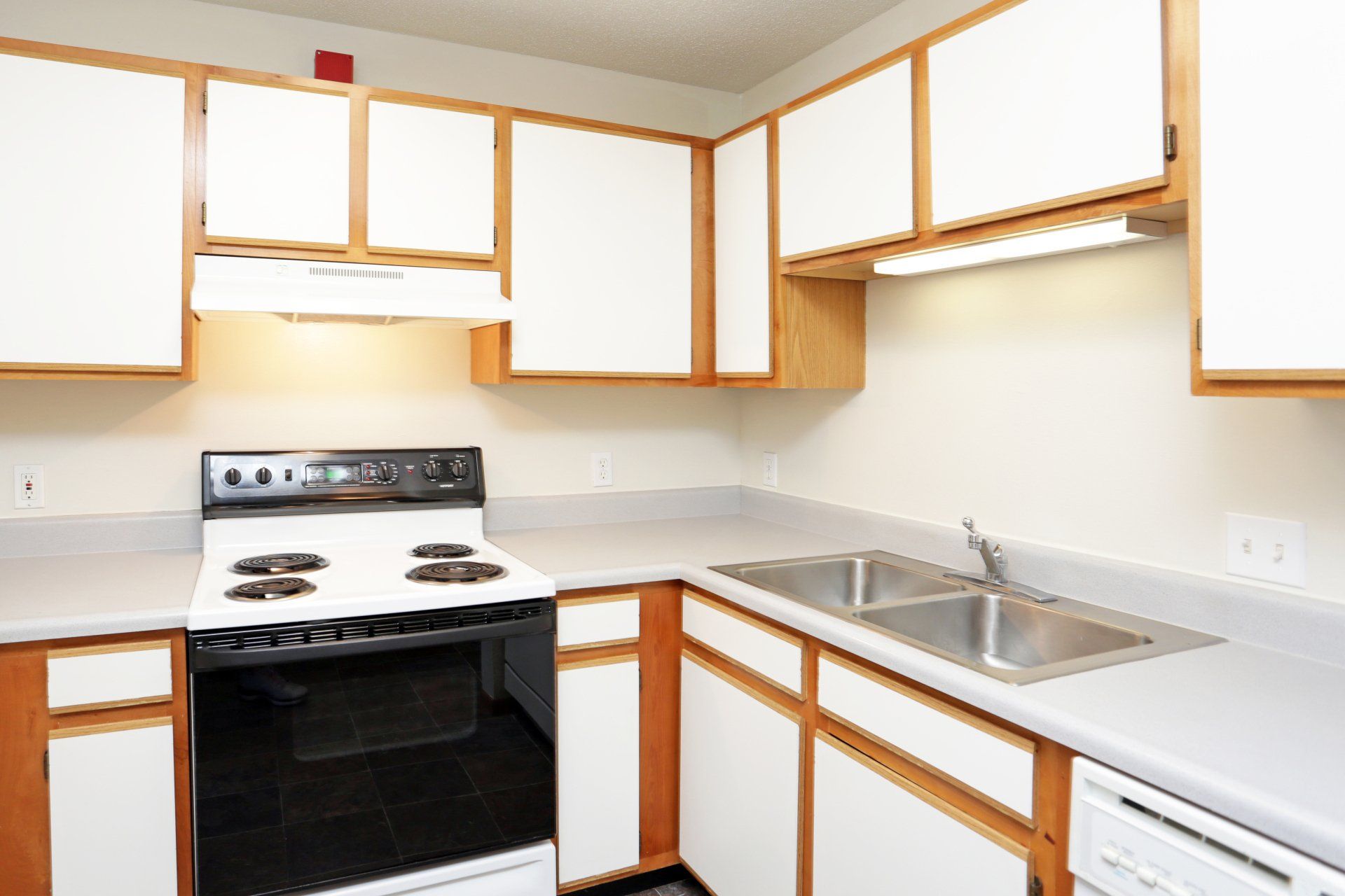 Kitchen with white cabinetry and wood finishes