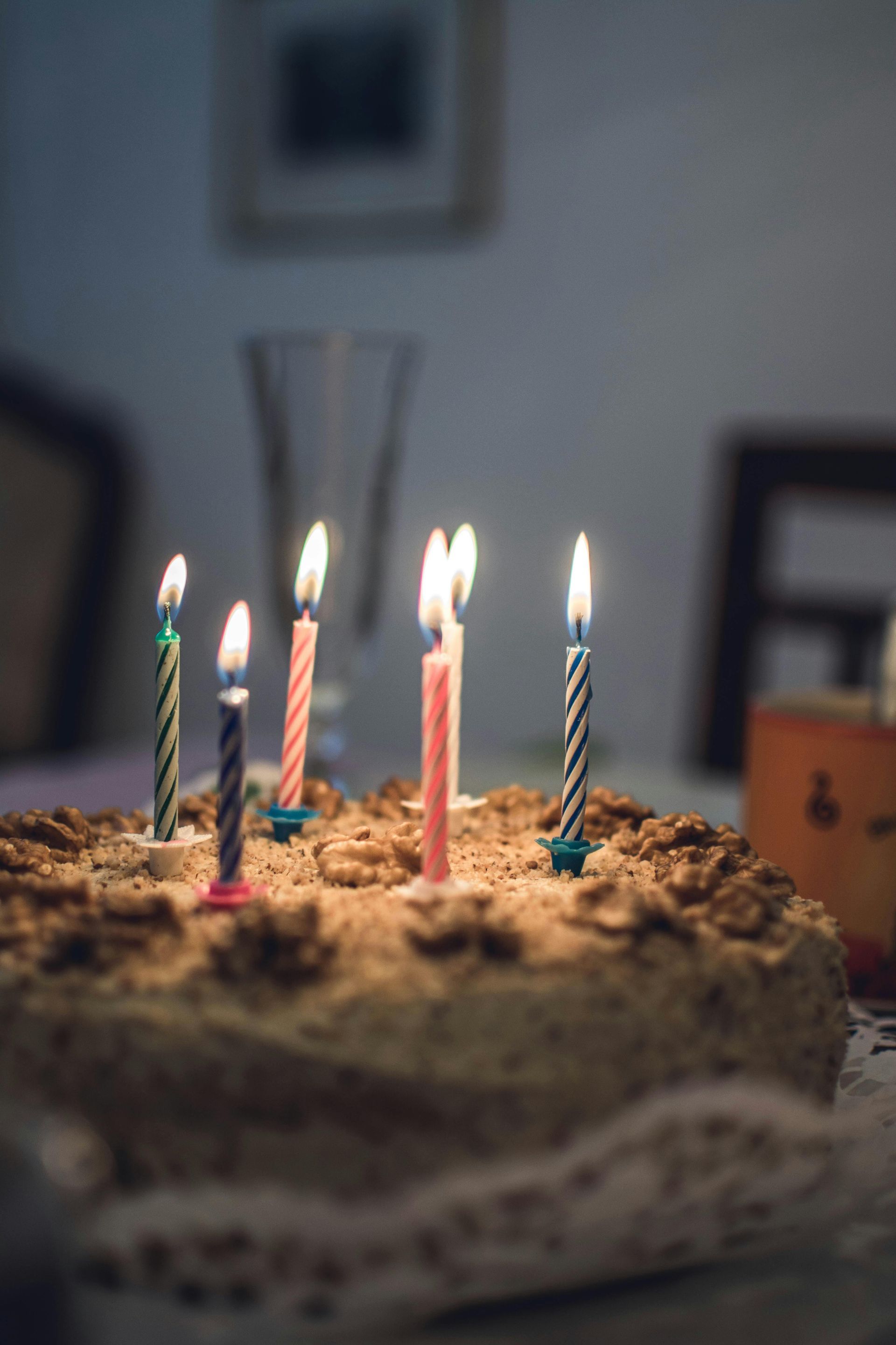 Birthday cake with lit candles on a table.