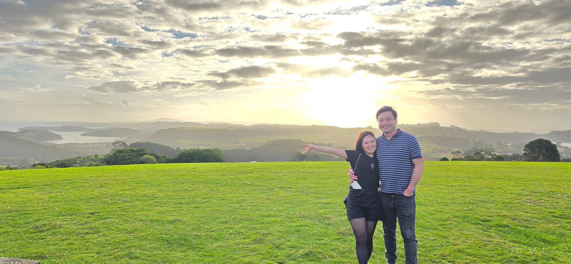 A couple enjoying the view from Trig Hill above Onetangi