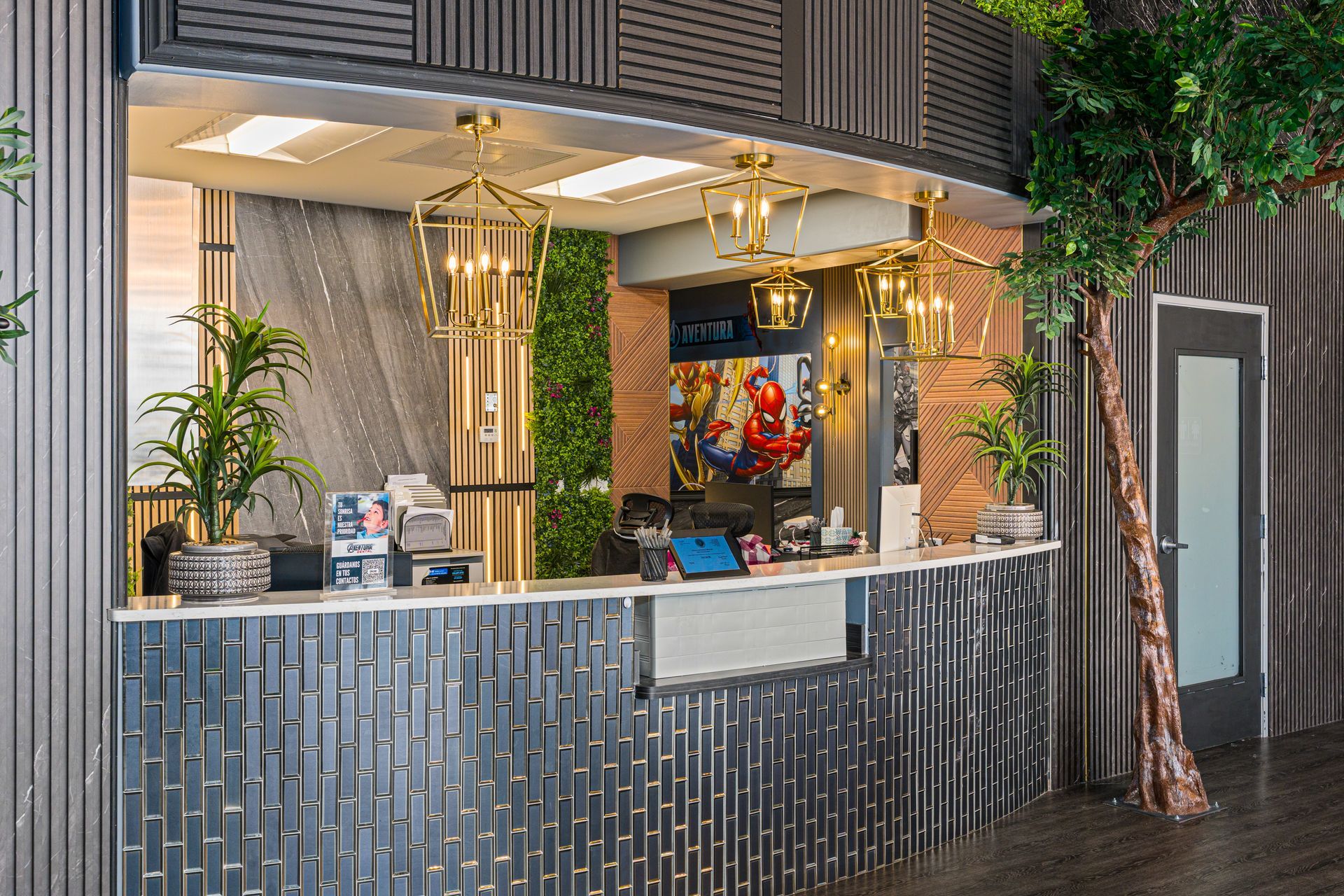 Outdoor café counter with gold decor, blue-gray paneling, potted plants, and a colorful artwork inside