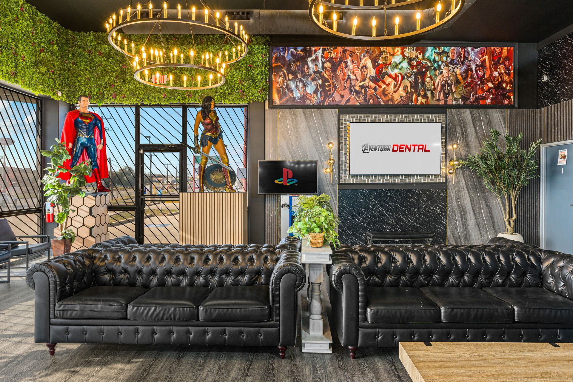 Stylish lounge with black leather sofas, neon lights, plants, and a Superman wall display