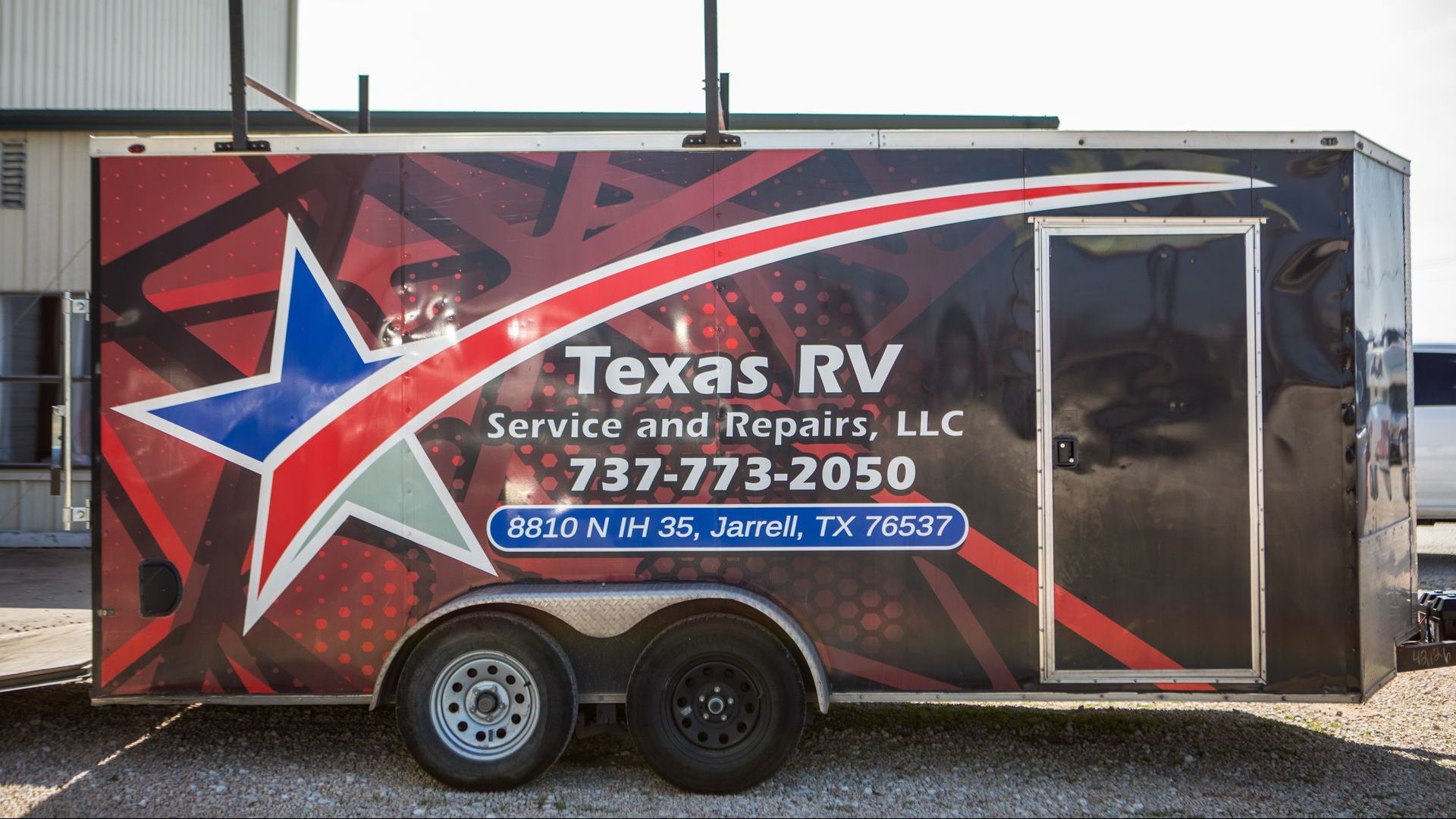 RV service trailer with Texas star logo and contact info.