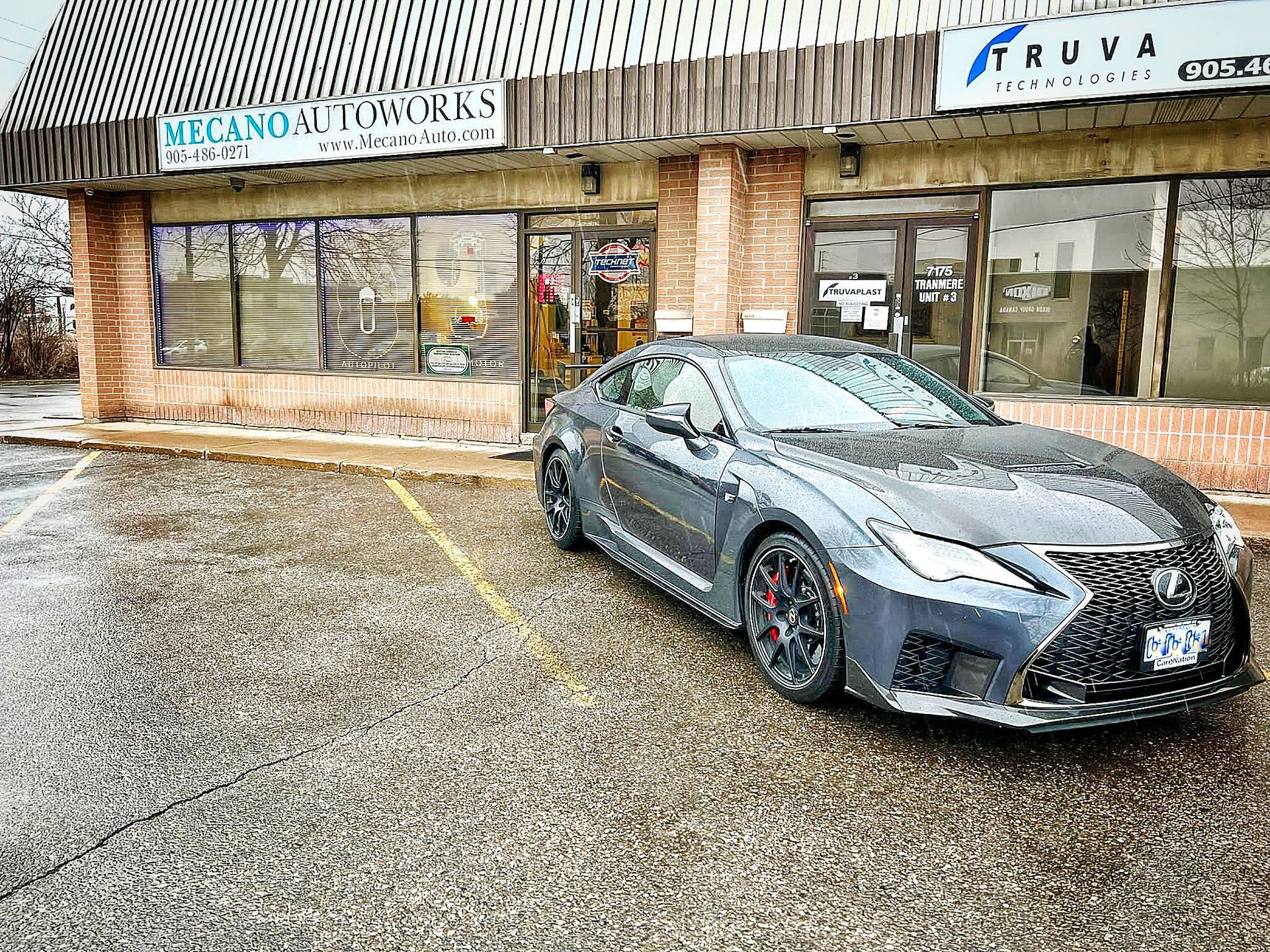 Gray Lexus coupe parked in front of Mecano Autoworks on a snowy day. | Mecano Autoworks