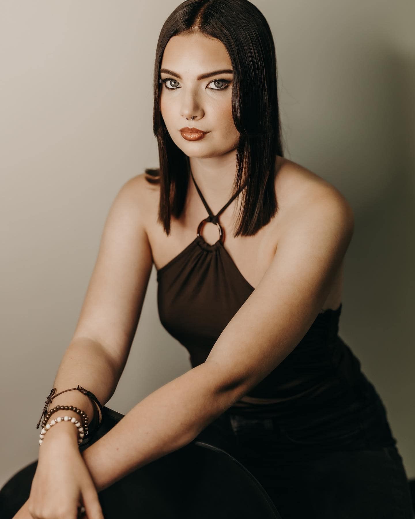 Woman in Dark Top and Pants, Posing Against a Light Background — EDISON Hair Collective In Mackay, QLD