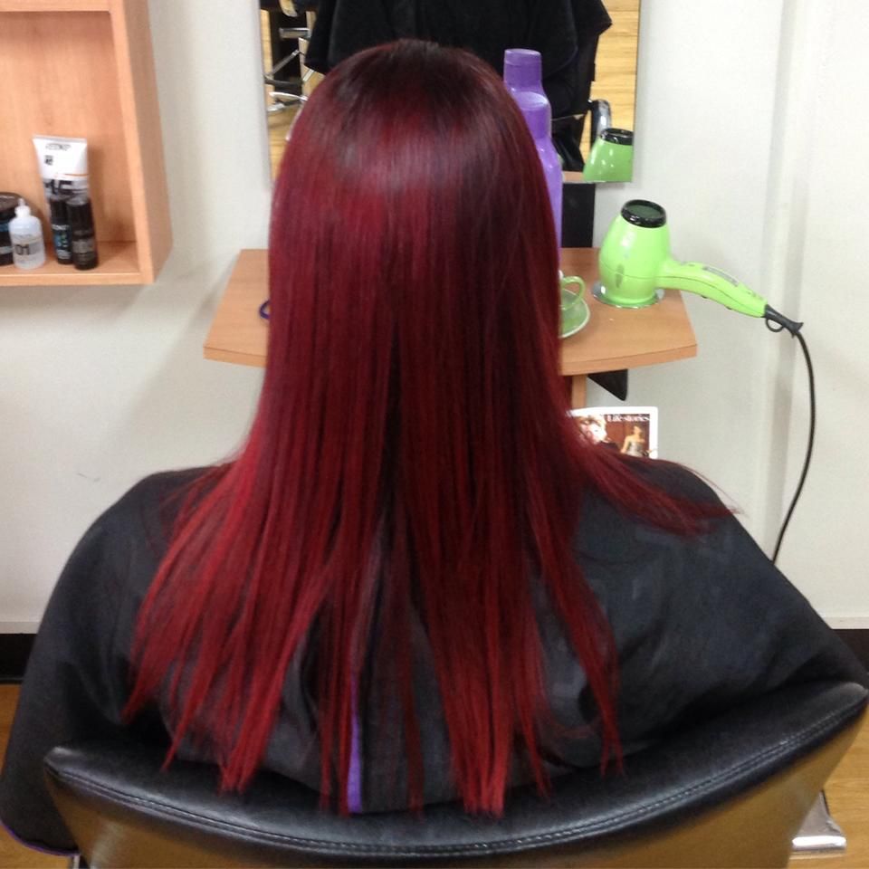 Person with Long, Straight, Vibrant Red Hair Sits in A Salon Chair — EDISON Hair Collective In Mackay, QLD
