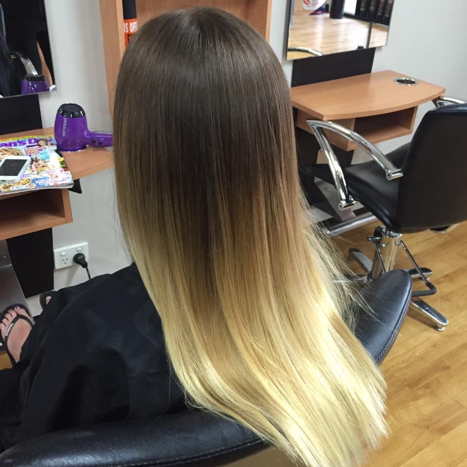 Woman with Long Hair Featuring a Brown to Blonde Ombre Style, Sitting in A Salon Chair — EDISON Hair Collective In Mackay, QLD