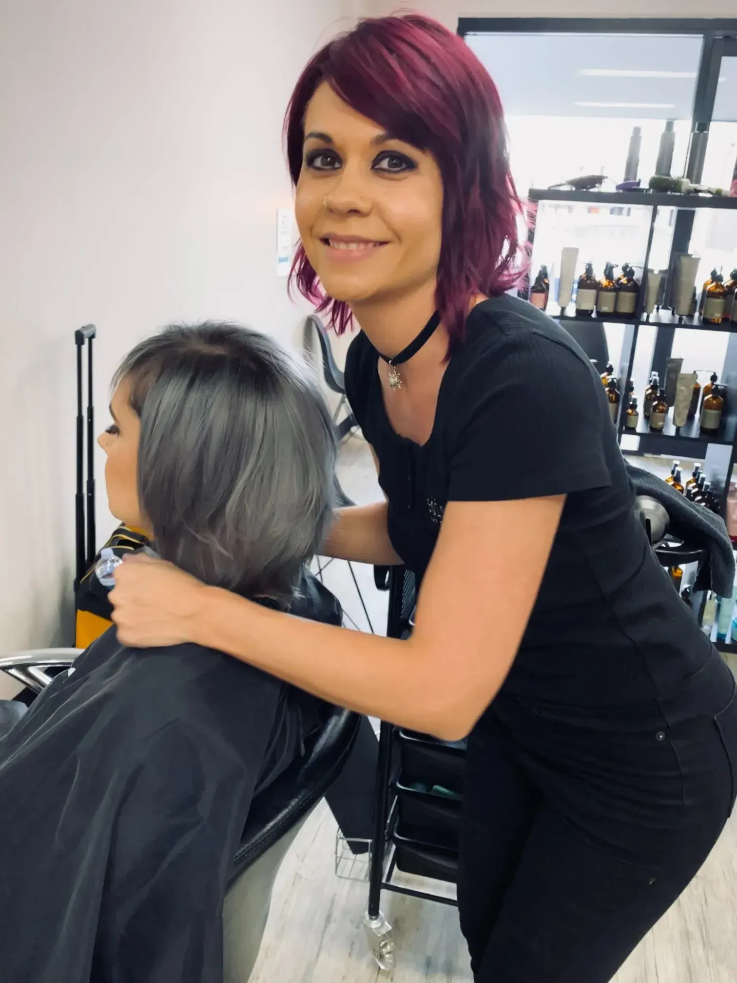 Hair Stylist with Red Hair, Touching a Client's Gray Bob Hairstyle in A Salon — EDISON Hair Collective In Mackay, QLD