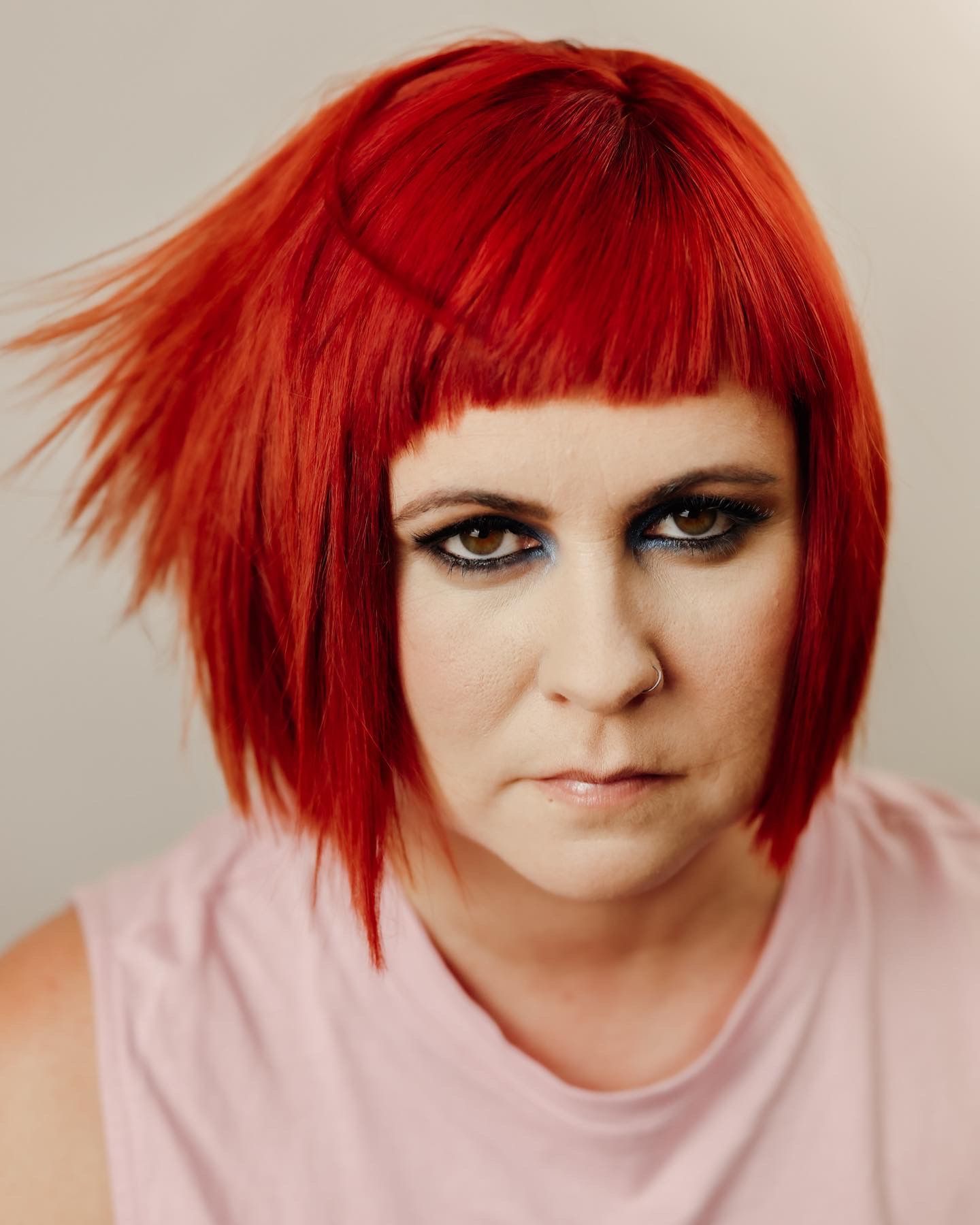 Woman with Short Red Hair and Smoky Eye Makeup, Looking Directly at The Viewer — EDISON Hair Collective In Mackay, QLD