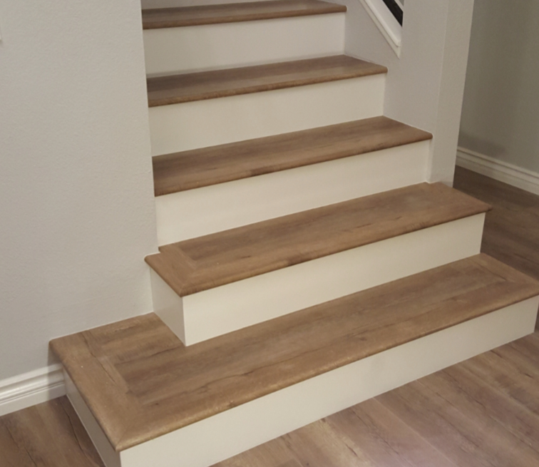 Indoor staircase with wood treads and white risers in a modern home