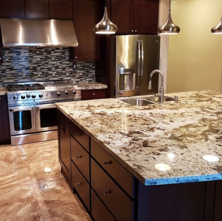 Modern kitchen with granite island, stainless steel appliances, and mosaic tile backsplash
