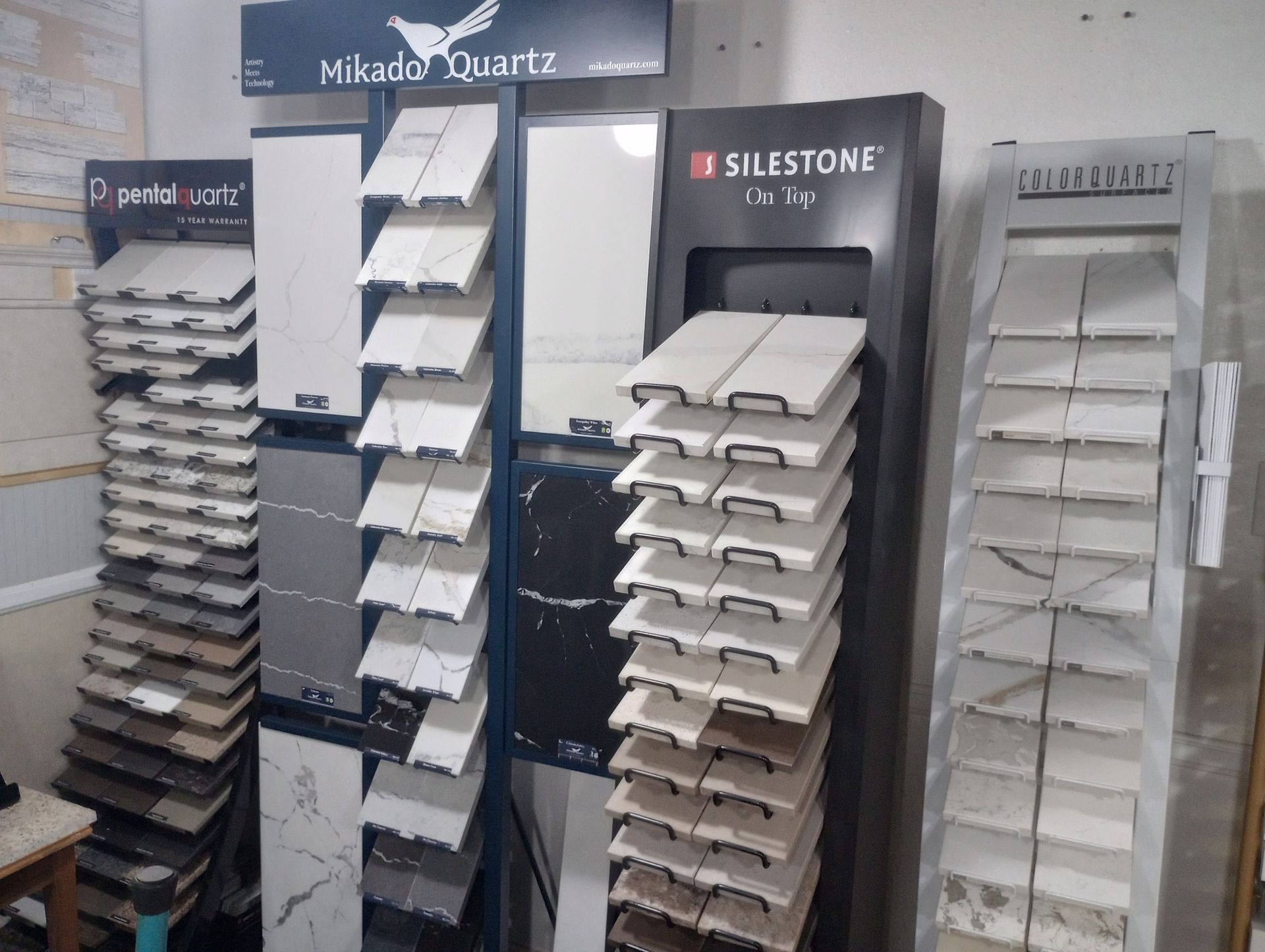 Wall of home siding and trim samples displayed in a showroom