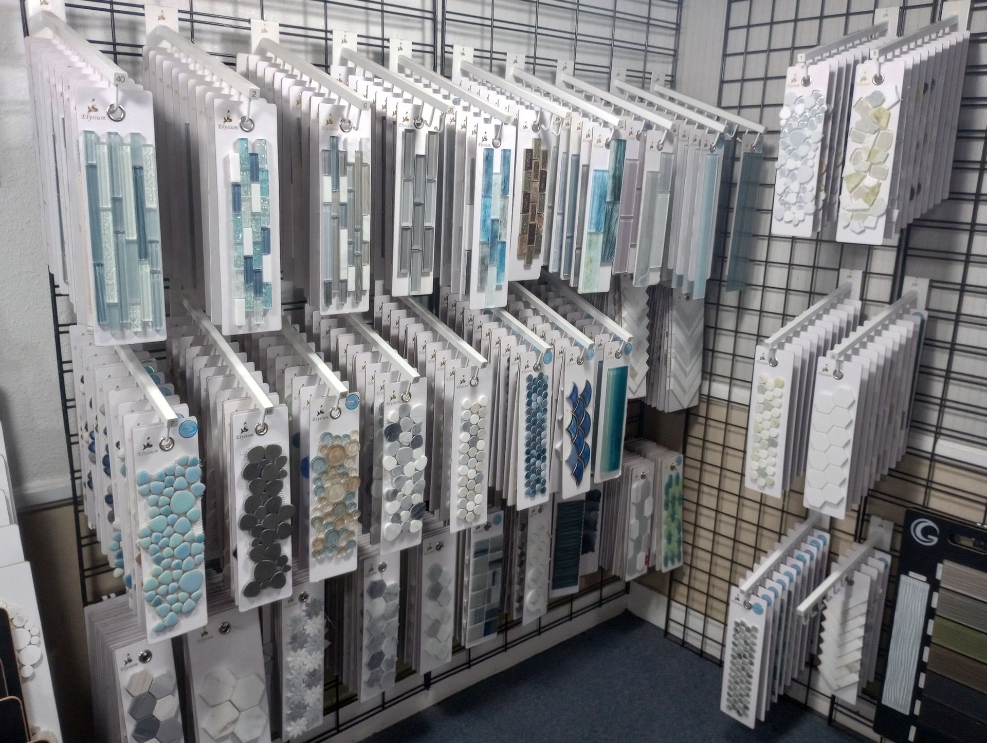 Pegboard display of packaged craft or stationery items in clear plastic sleeves on store racks