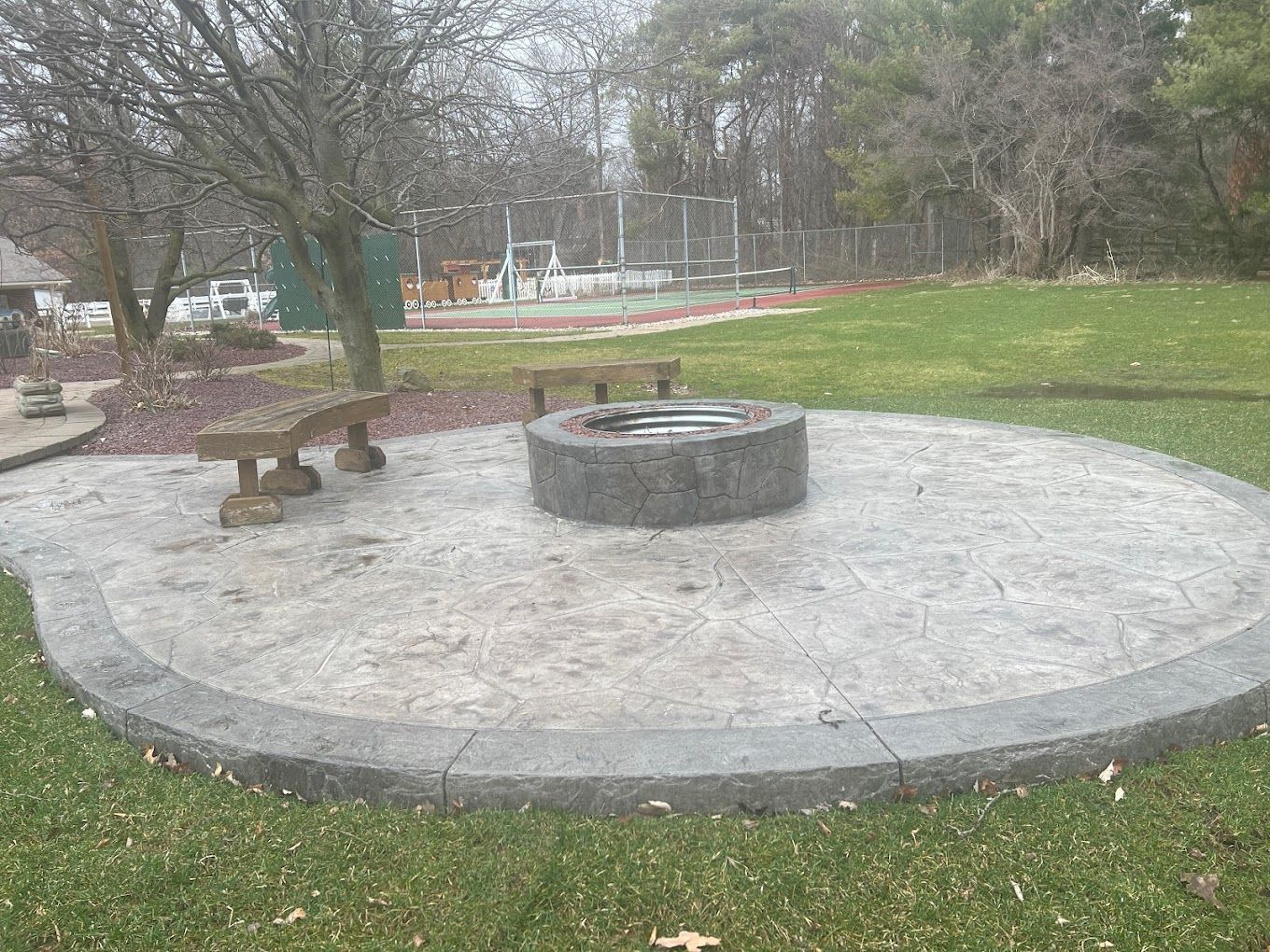 There is a fire pit in the middle of the park.