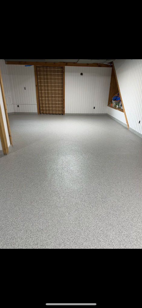 A large empty room with a white floor and white walls.