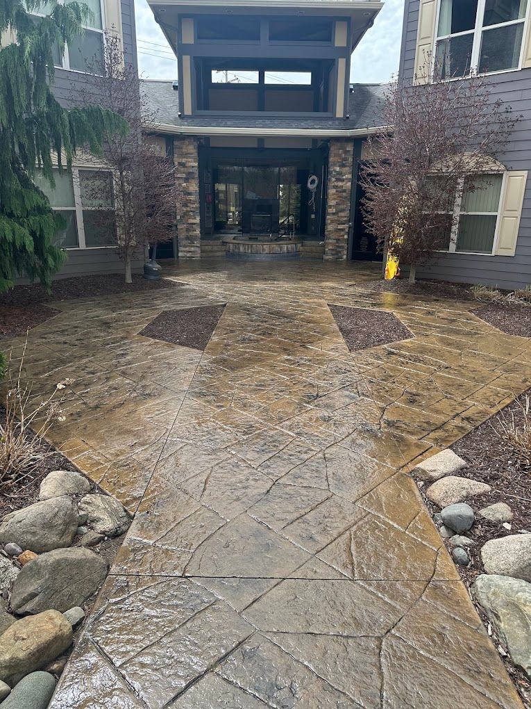 A concrete walkway leading to the entrance of a building.