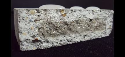 A close up of a piece of concrete with water drops on it.