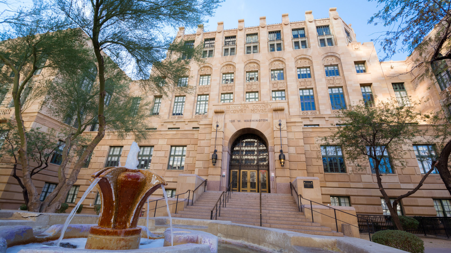 A large building with a fountain in front of it