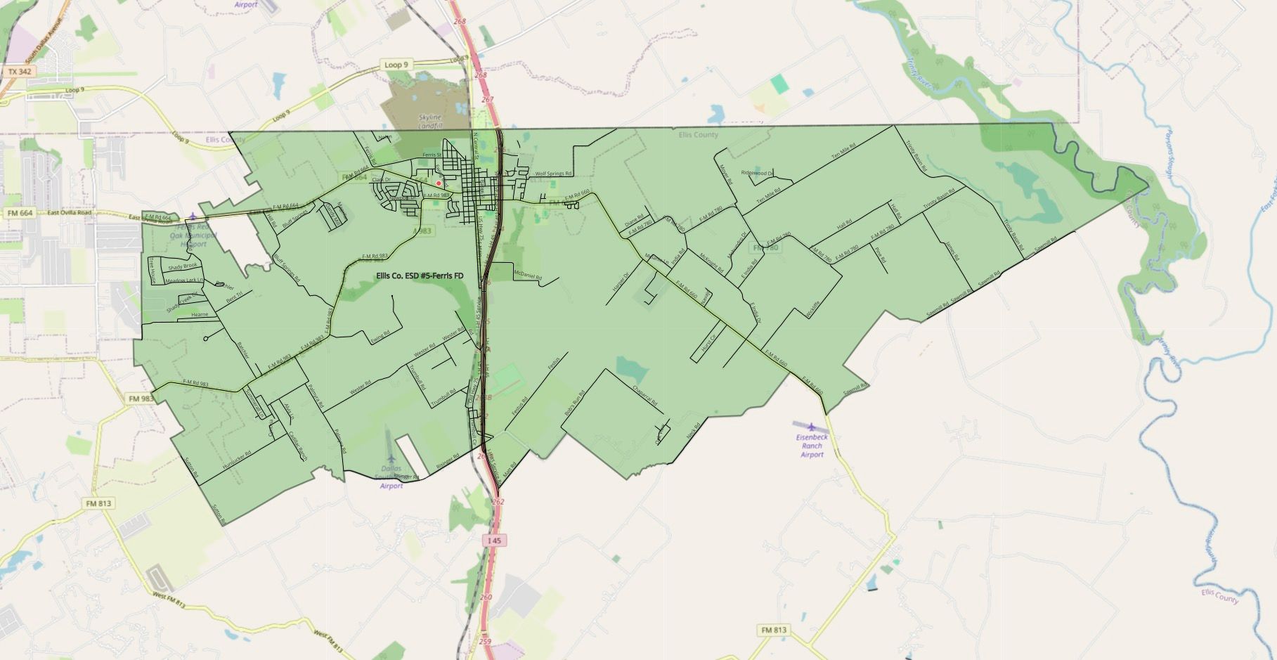 Map of a green-shaded area, likely a municipality or county, with roads and some buildings.