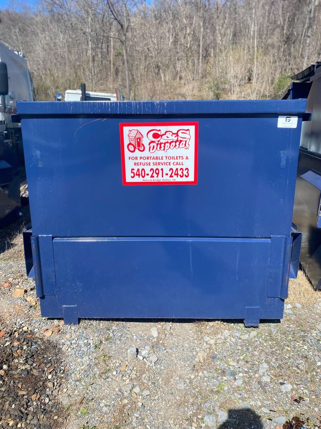 Blue dumpster with red and white logo; outdoors.