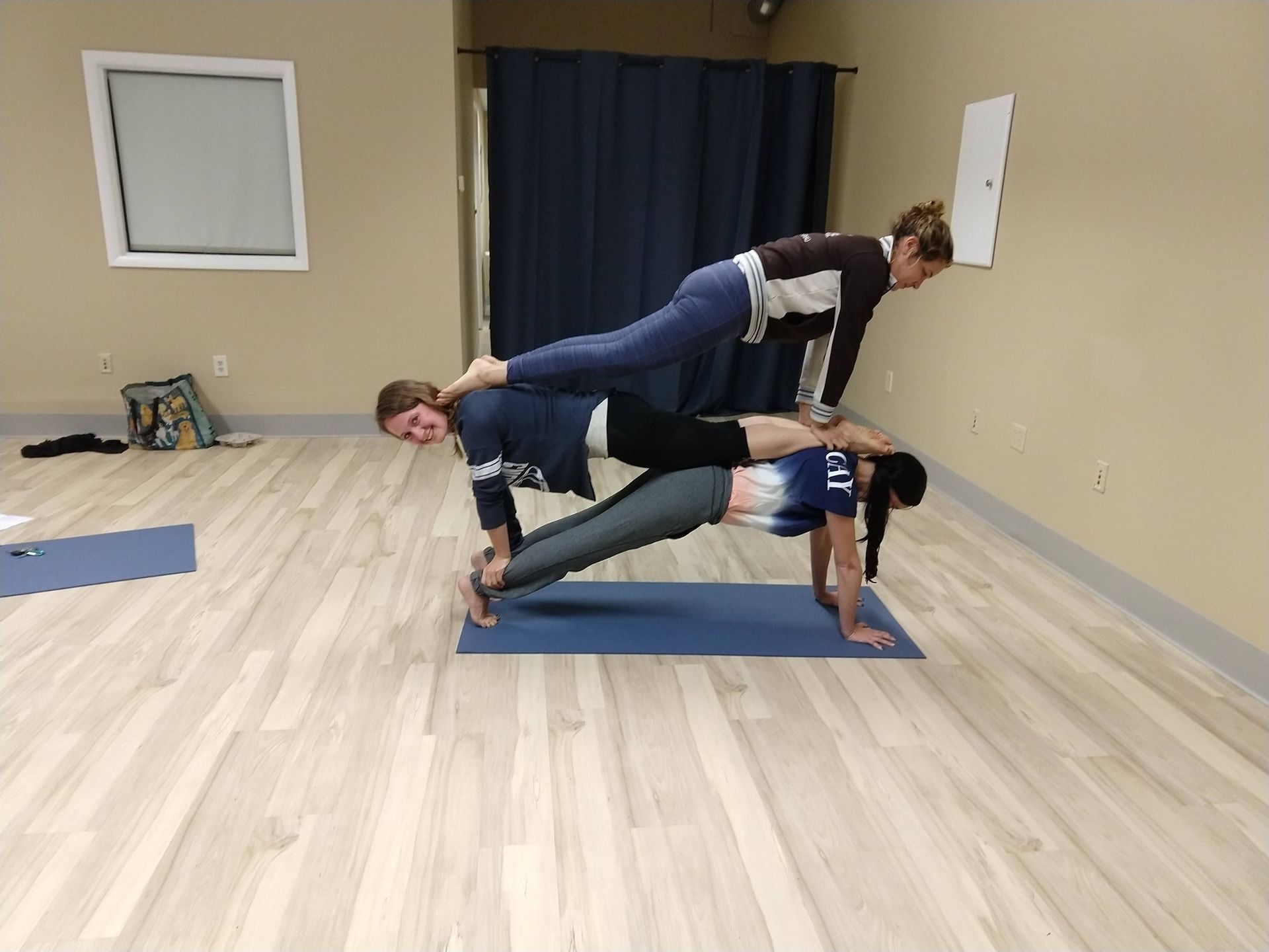 Teacher training participants practicing partner poses in the studio