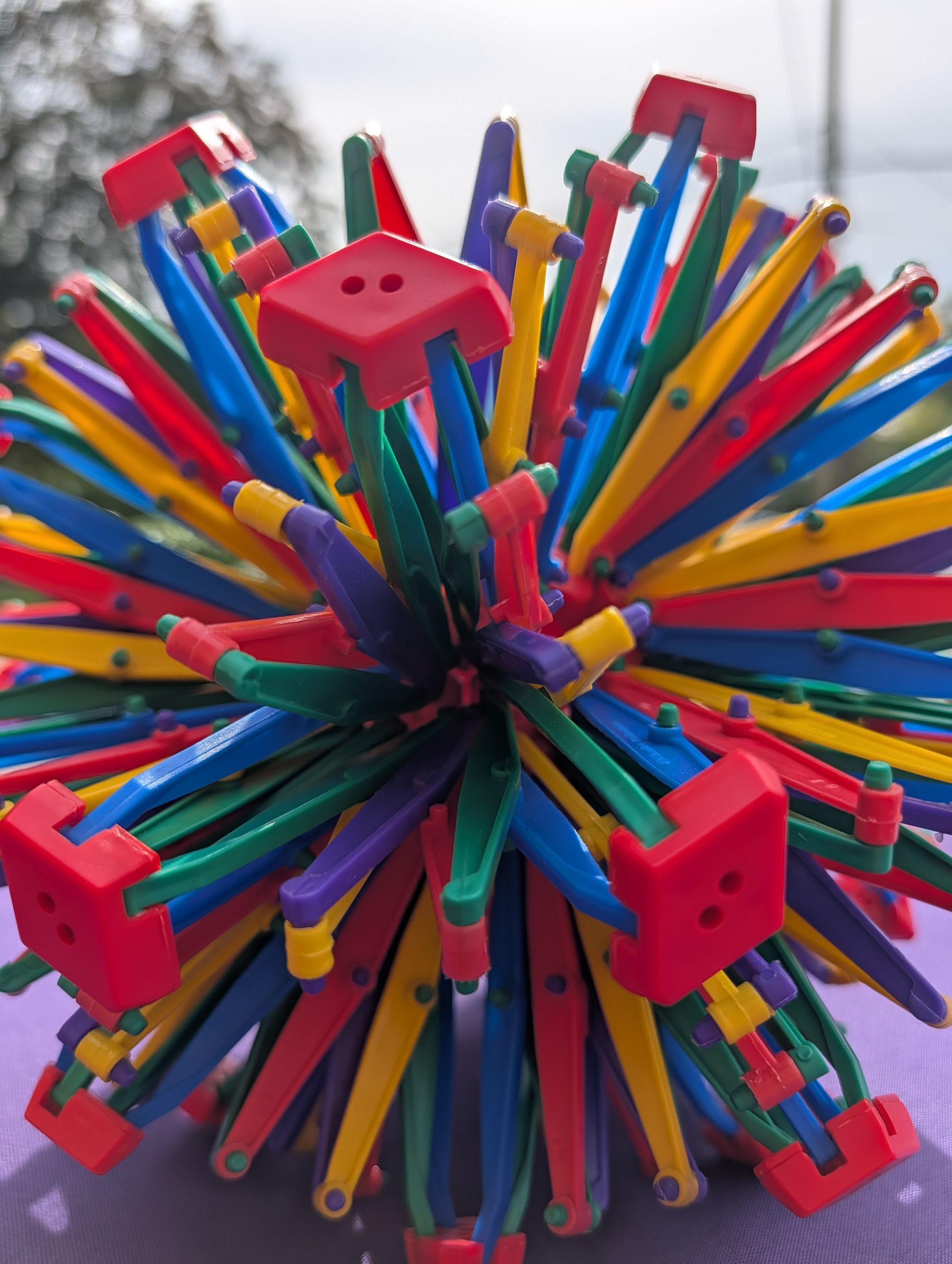 Child using a Hoberman sphere breathing ball