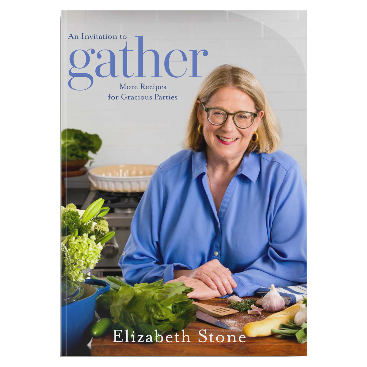 Elizabeth Stone smiles at a table with plants and food on the cover of Gather magazine.