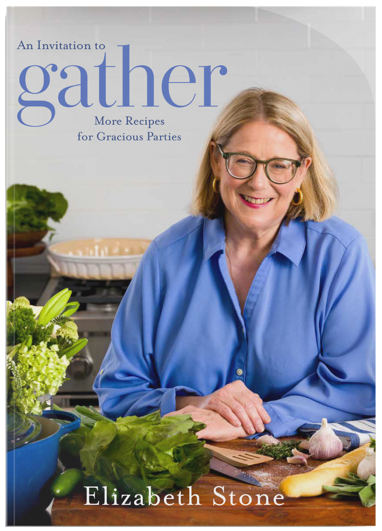 Book cover of Elizabeth Stone smiling in a blue shirt, seated beside a table with vegetables and kitchen items.